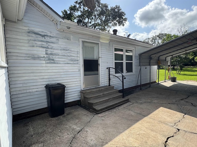 2515 Date St, Port Arthur, TX 77642 - doorway to property featuring a yard and a detached carport