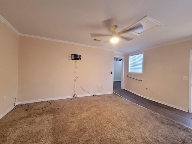 unfurnished room featuring baseboards, attic access, visible vents, and crown molding