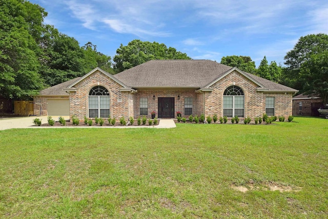 single story home featuring a garage and a front yard