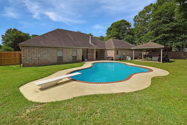 view of swimming pool featuring a yard, a diving board, a patio, and a gazebo