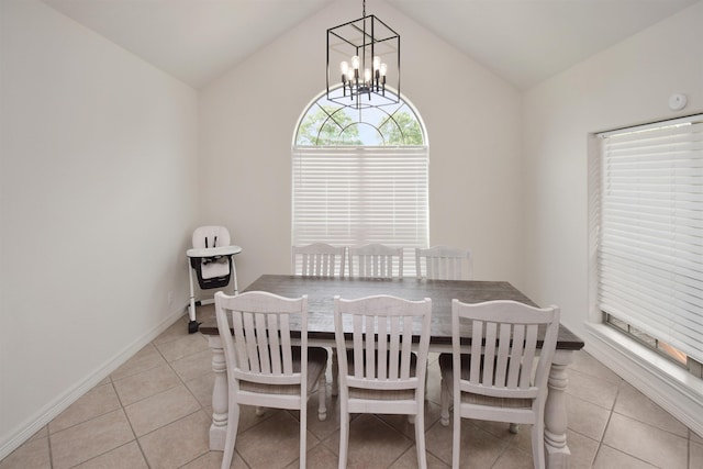 dining room with a notable chandelier, vaulted ceiling, and light tile patterned floors