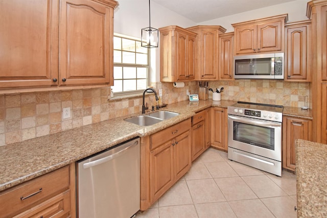 kitchen with pendant lighting, sink, light tile patterned floors, stainless steel appliances, and decorative backsplash