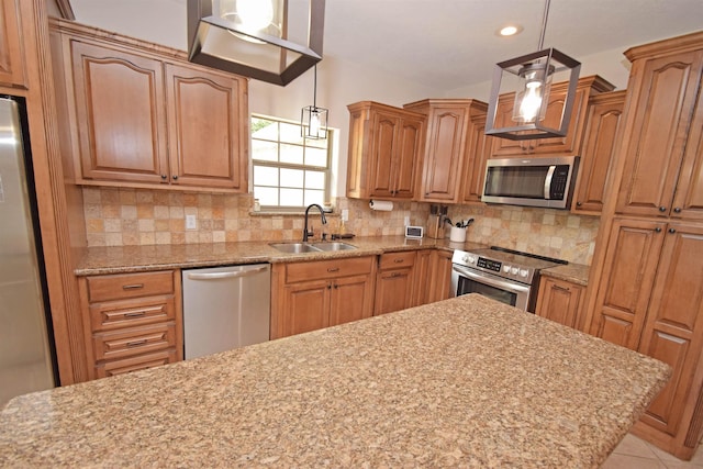 kitchen featuring tasteful backsplash, appliances with stainless steel finishes, and sink