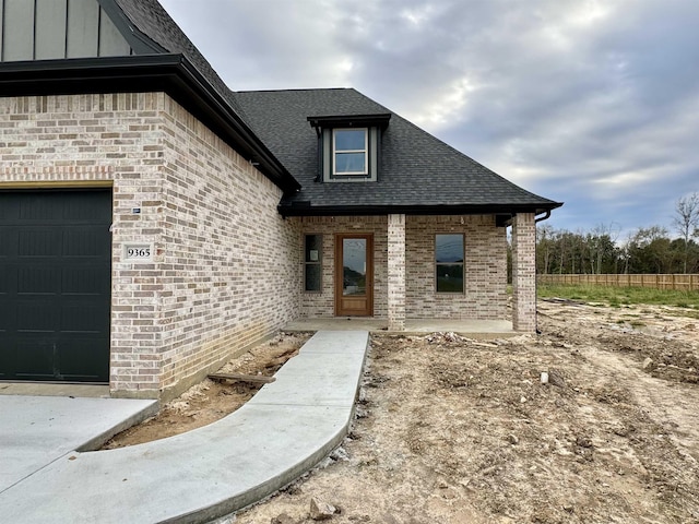 doorway to property featuring a garage