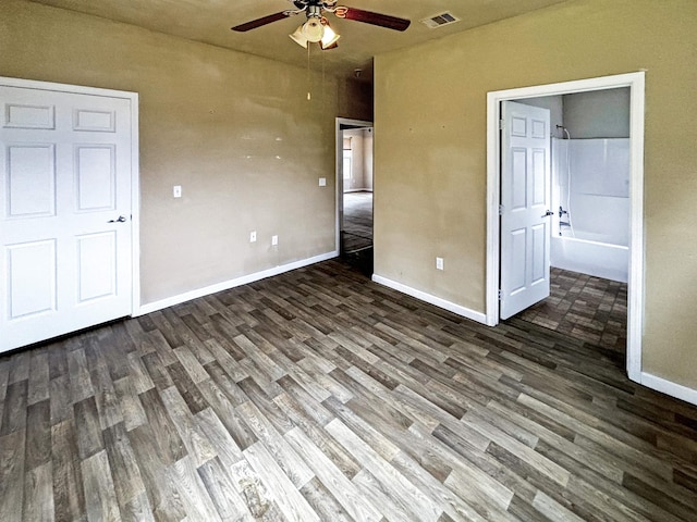 unfurnished bedroom with dark hardwood / wood-style floors and ceiling fan