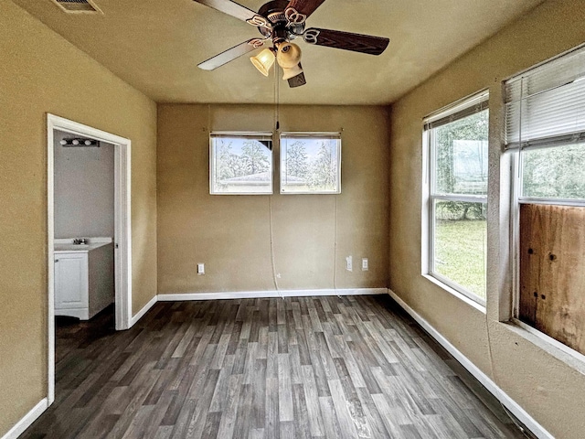 interior space featuring a wealth of natural light, ceiling fan, and dark hardwood / wood-style floors