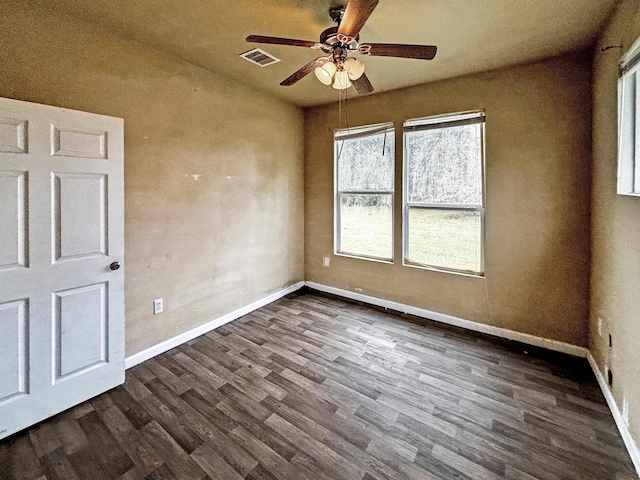 unfurnished room with dark hardwood / wood-style floors and ceiling fan