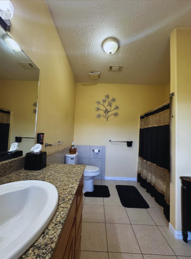 8135 Dawn Dr, Beaumont, TX 77705 - full bathroom with vanity, tile patterned floors, toilet, a textured ceiling, and a shower with shower curtain