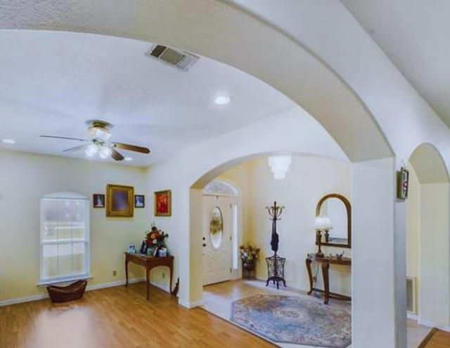 8135 Dawn Dr, Beaumont, TX 77705 - foyer featuring arched walkways, a ceiling fan, wood finished floors, and recessed lighting