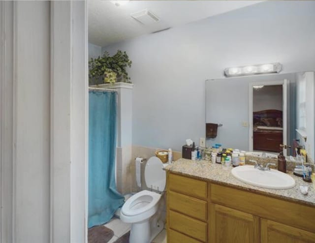 8135 Dawn Dr, Beaumont, TX 77705 - full bathroom with vanity, toilet, and a shower with shower curtain