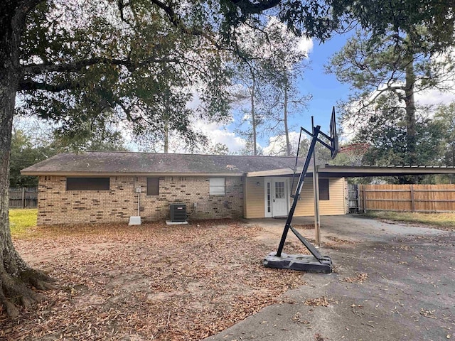 back of house with a carport and cooling unit