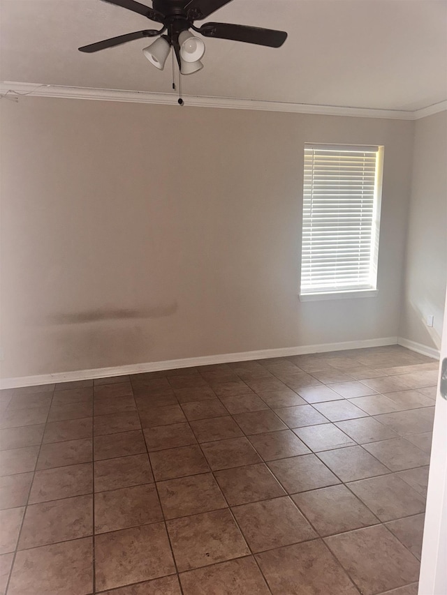 tiled empty room with ceiling fan and crown molding