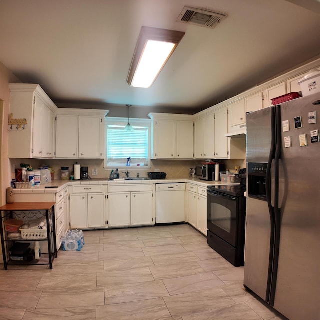 kitchen with white cabinets, appliances with stainless steel finishes, and sink