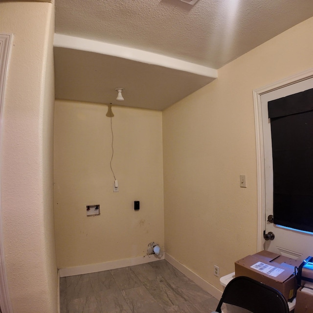 laundry area with hookup for a washing machine and a textured ceiling