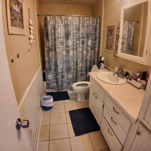 full bathroom featuring tile patterned floors, vanity, toilet, and shower / bath combo with shower curtain