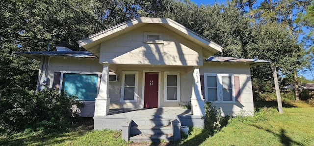 bungalow-style home with a front lawn