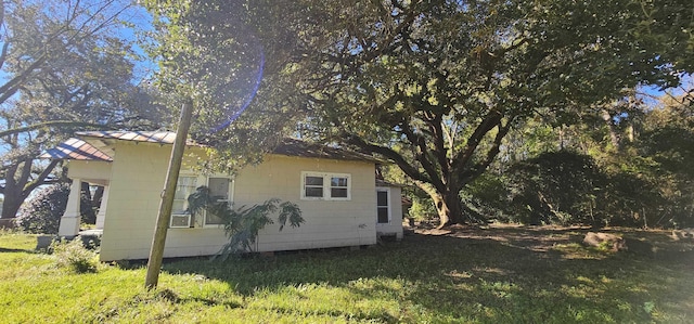 view of side of home featuring a yard