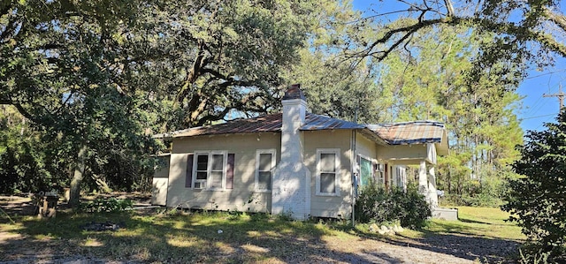 view of property exterior with a yard