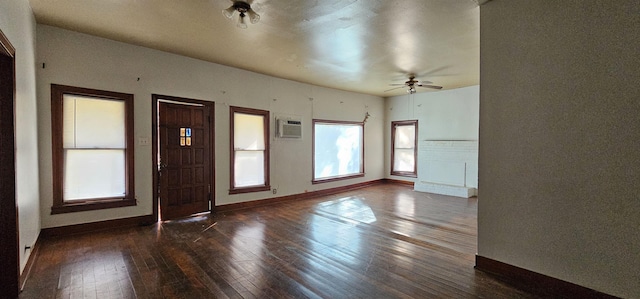 foyer entrance featuring dark hardwood / wood-style flooring, a wall mounted air conditioner, and ceiling fan