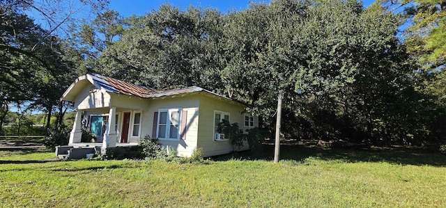 view of side of property with a yard