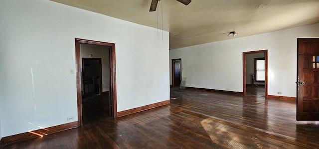 spare room with ceiling fan and dark hardwood / wood-style flooring