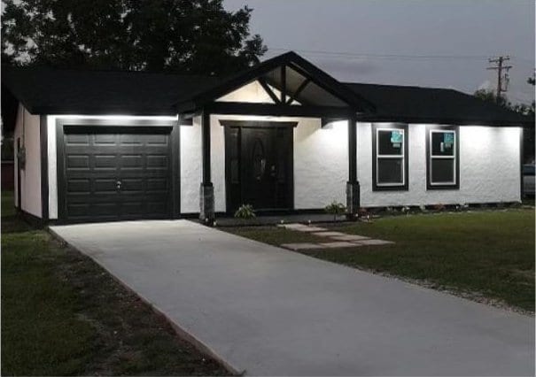 single story home with a garage and a front yard