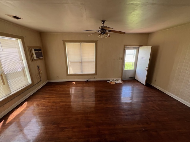 2849 12th St, Port Arthur, TX 77642 - spare room featuring dark wood-style floors, a wall mounted air conditioner, and ceiling fan