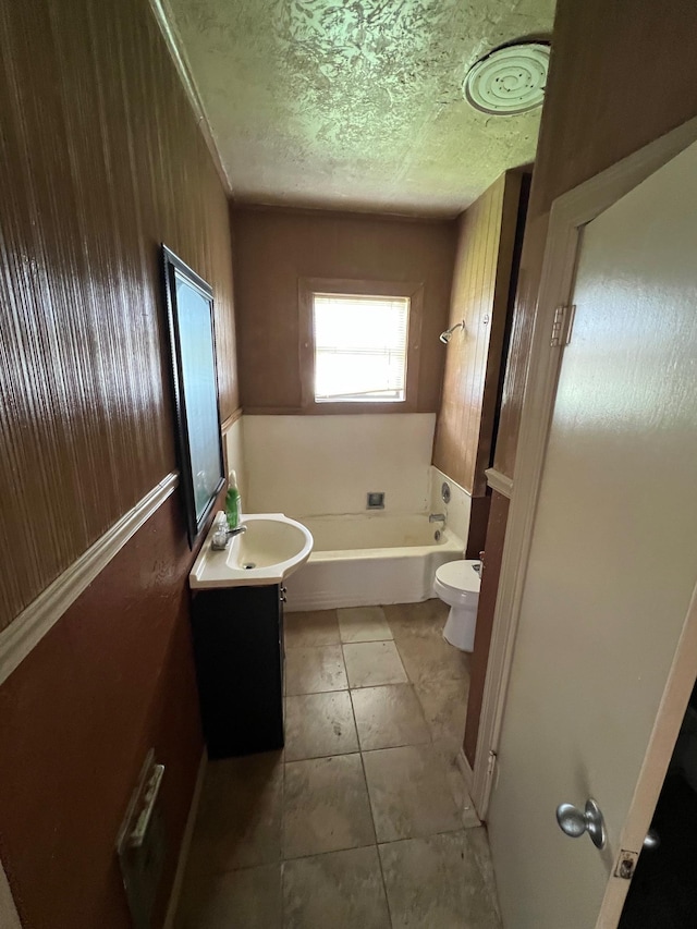 2849 12th St, Port Arthur, TX 77642 - full bathroom with a bath, vanity, tile patterned floors, and a textured ceiling