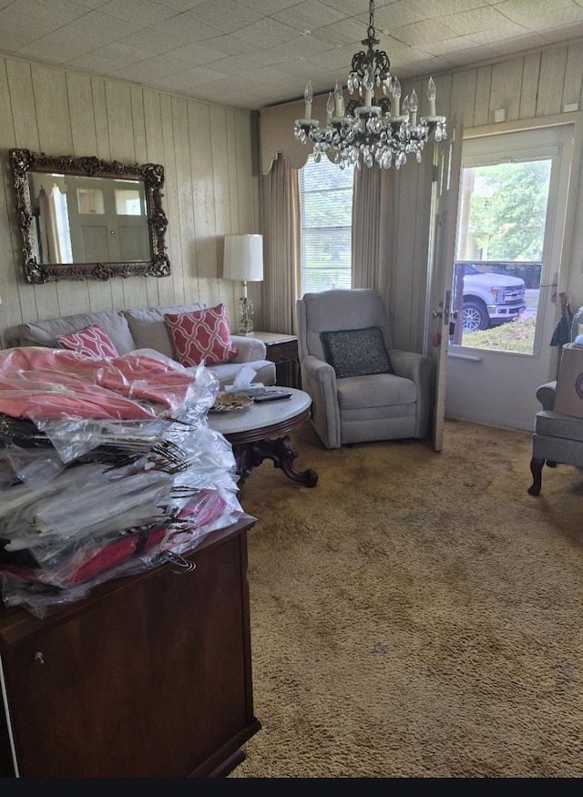 301 Morrell Blvd, Orange, TX 77630 - living room featuring wooden walls, a chandelier, and carpet floors