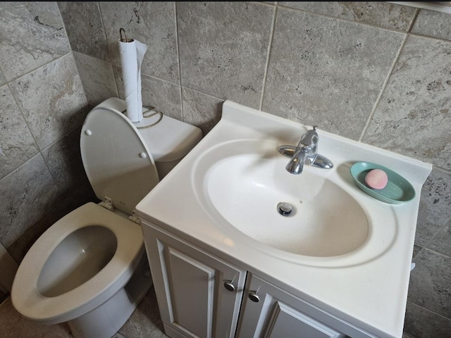 301 Morrell Blvd, Orange, TX 77630 - bathroom with tile walls, vanity, and toilet