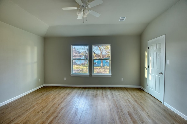 unfurnished room with ceiling fan, light hardwood / wood-style floors, and vaulted ceiling