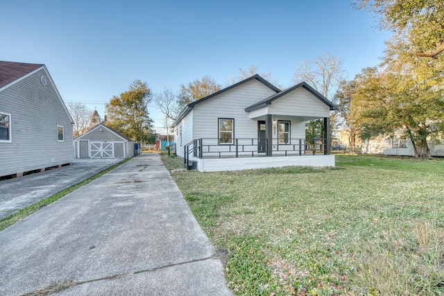 view of front of house featuring a front lawn, a porch, and a storage shed