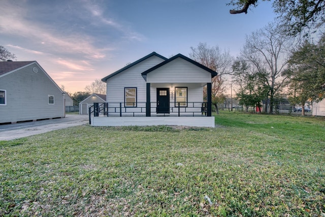 view of front of property with covered porch and a yard