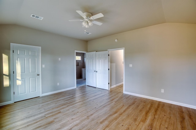 unfurnished bedroom featuring ceiling fan, lofted ceiling, and light wood-type flooring