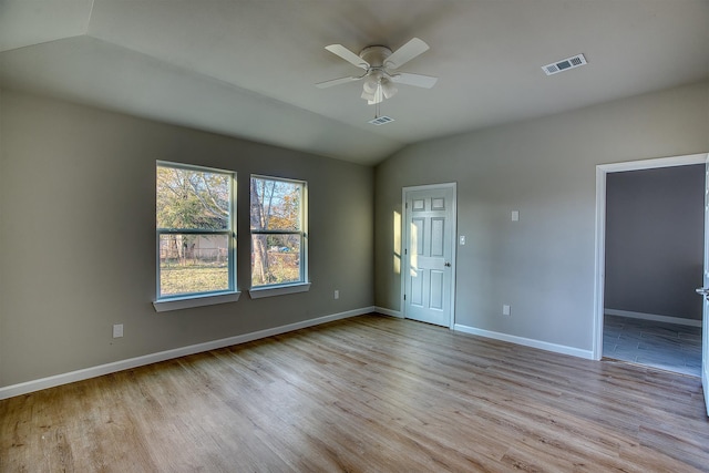 unfurnished room with light hardwood / wood-style floors, vaulted ceiling, and ceiling fan