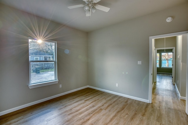 spare room featuring light hardwood / wood-style flooring and ceiling fan