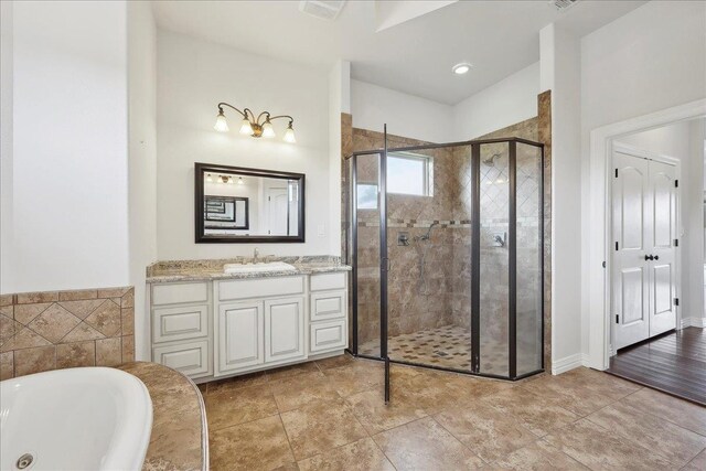 1215 Bourbon St, Bridge City, TX 77611 - bathroom with a shower stall, vanity, and a whirlpool tub