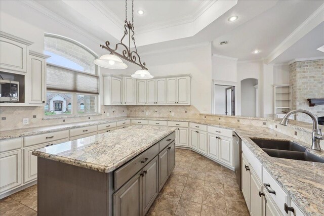 1215 Bourbon St, Bridge City, TX 77611 - kitchen with a sink, appliances with stainless steel finishes, arched walkways, decorative backsplash, and crown molding