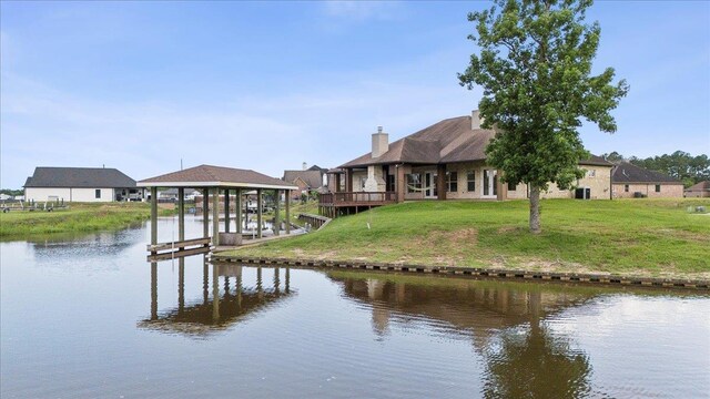 1215 Bourbon St, Bridge City, TX 77611 - dock with boat lift, a water view, and a yard