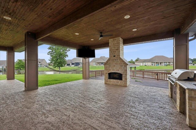 1215 Bourbon St, Bridge City, TX 77611 - view of patio featuring an outdoor brick fireplace, exterior kitchen, a residential view, and a ceiling fan