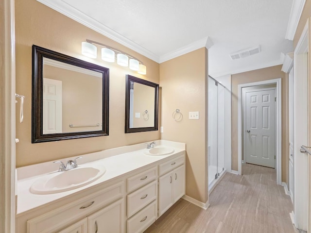 3760 Seminole Dr, Beaumont, TX 77707 - full bathroom featuring a stall shower, double vanity, crown molding, baseboards, and wood finished floors