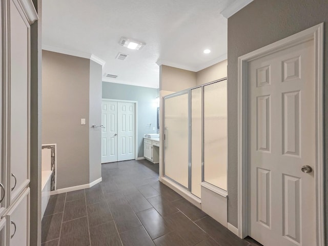 3760 Seminole Dr, Beaumont, TX 77707 - bathroom with ornamental molding, a stall shower, a garden tub, baseboards, and vanity