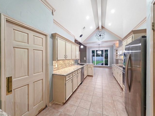 3760 Seminole Dr, Beaumont, TX 77707 - kitchen featuring appliances with stainless steel finishes, light tile patterned flooring, a sink, decorative backsplash, and hanging light fixtures