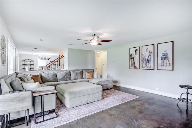 109 Twin Pines Cir, Beaumont, TX 77705 - living area with concrete flooring, a ceiling fan, baseboards, and a chandelier