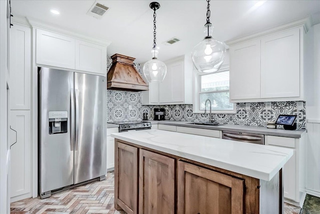 109 Twin Pines Cir, Beaumont, TX 77705 - kitchen with appliances with stainless steel finishes, custom range hood, a sink, tasteful backsplash, and white cabinets