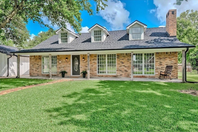 109 Twin Pines Cir, Beaumont, TX 77705 - view of front of house with brick siding, a front lawn, a chimney, and a shingled roof