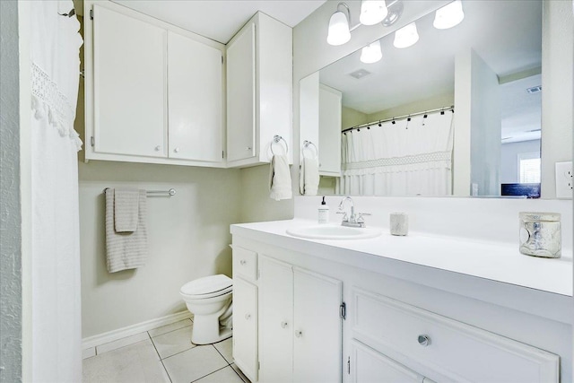 109 Twin Pines Cir, Beaumont, TX 77705 - bathroom featuring toilet, vanity, tile patterned flooring, and baseboards
