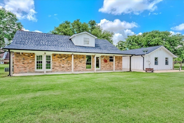 109 Twin Pines Cir, Beaumont, TX 77705 - back of property with a lawn, brick siding, a patio, central air condition unit, and a shingled roof