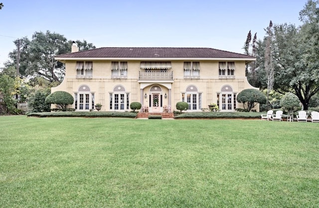 view of front of home with a front lawn and french doors