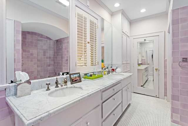 bathroom featuring tile patterned flooring, vanity, tiled shower, and ornamental molding